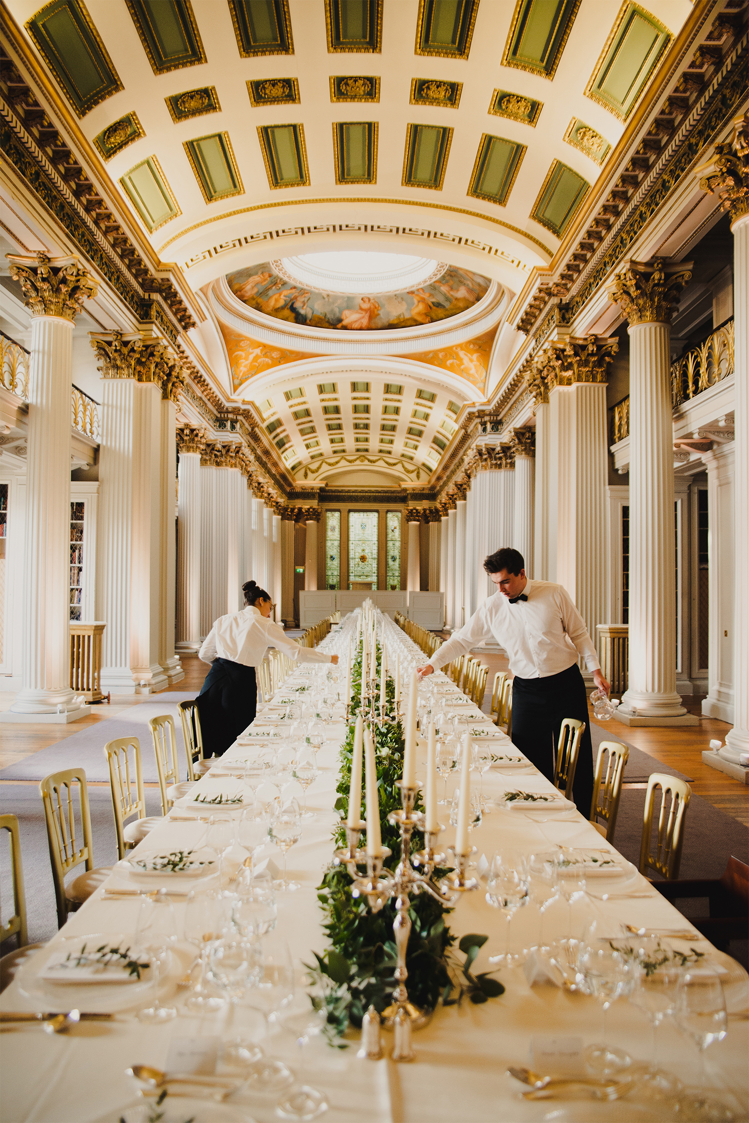 Waiting staff doing finishing touches for the wedding at the Signet Library.