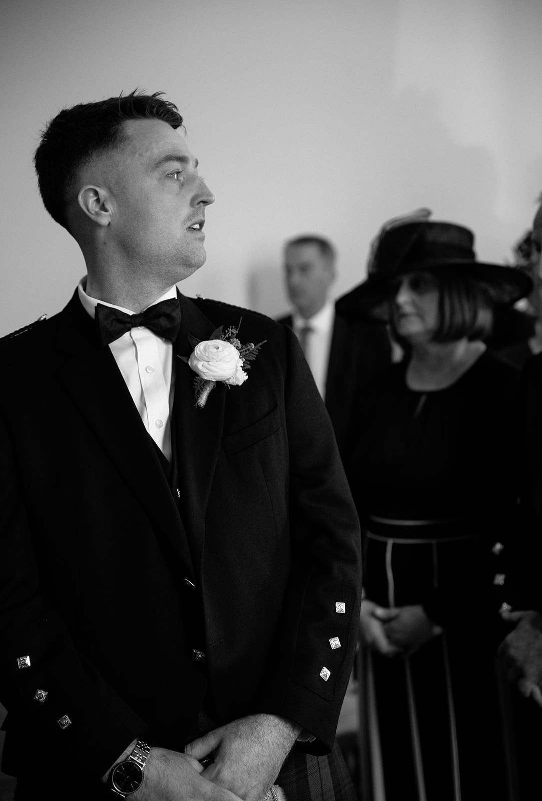 Grooms reaction while bride is walking down the aisle.