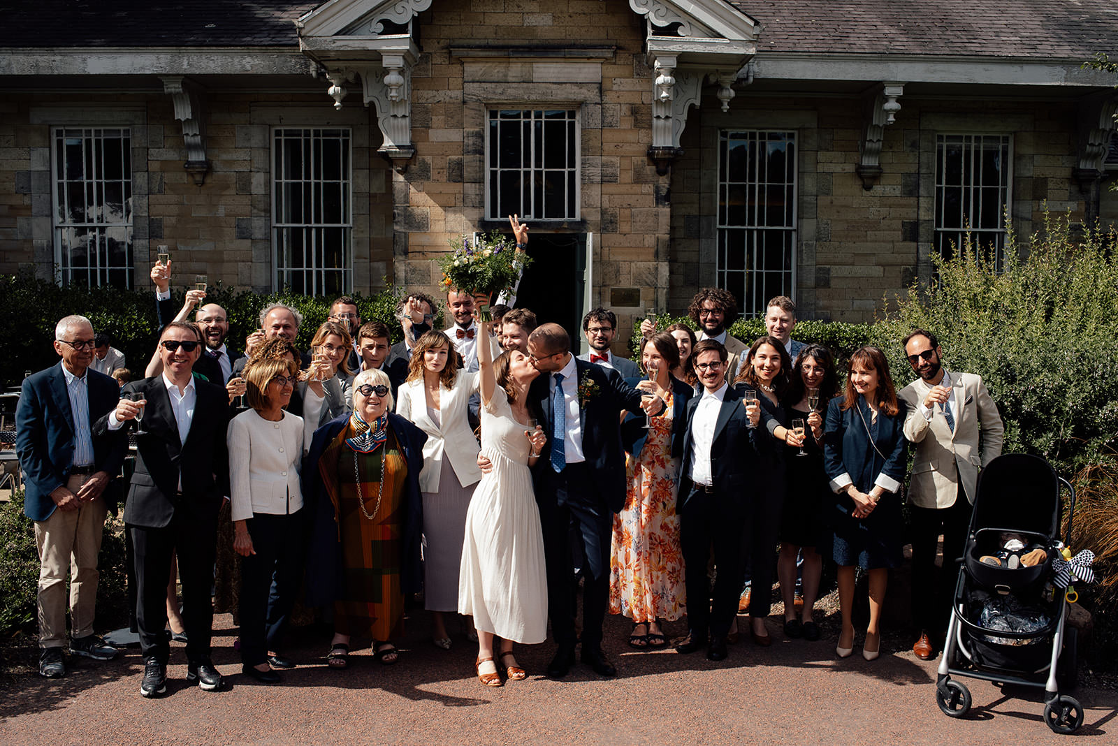 Group photo outside the Caledonian Hall at a wedding.