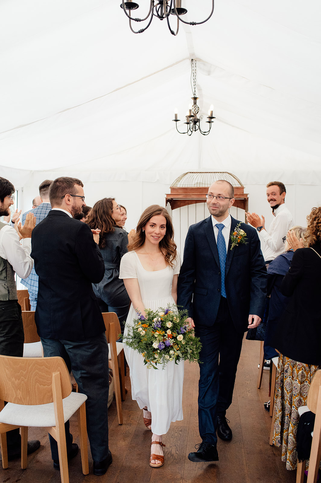 Couple walking down the aisle just married at the Caledonian Hall.