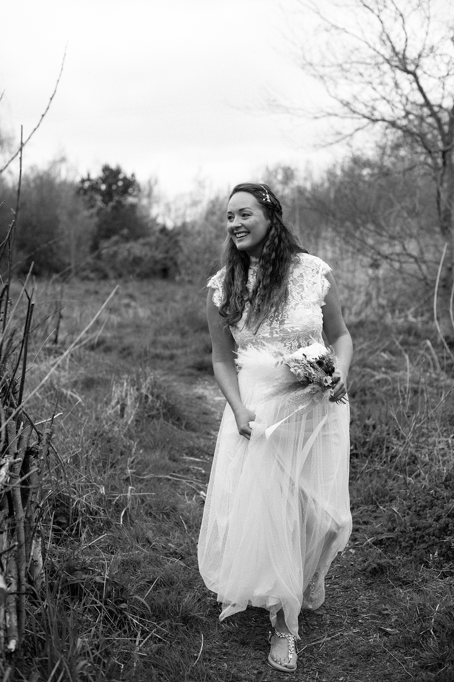 Bride walking down the field to meet her future husband.