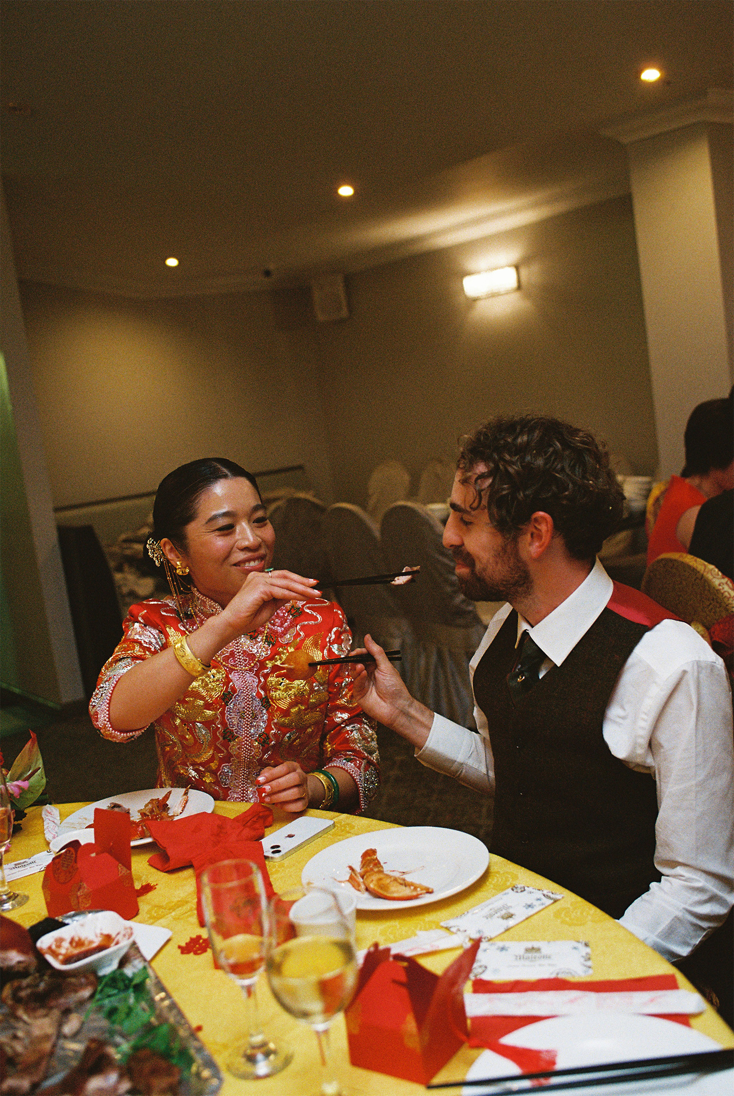 Chinese bride feeding her Scottish husband dumplings.