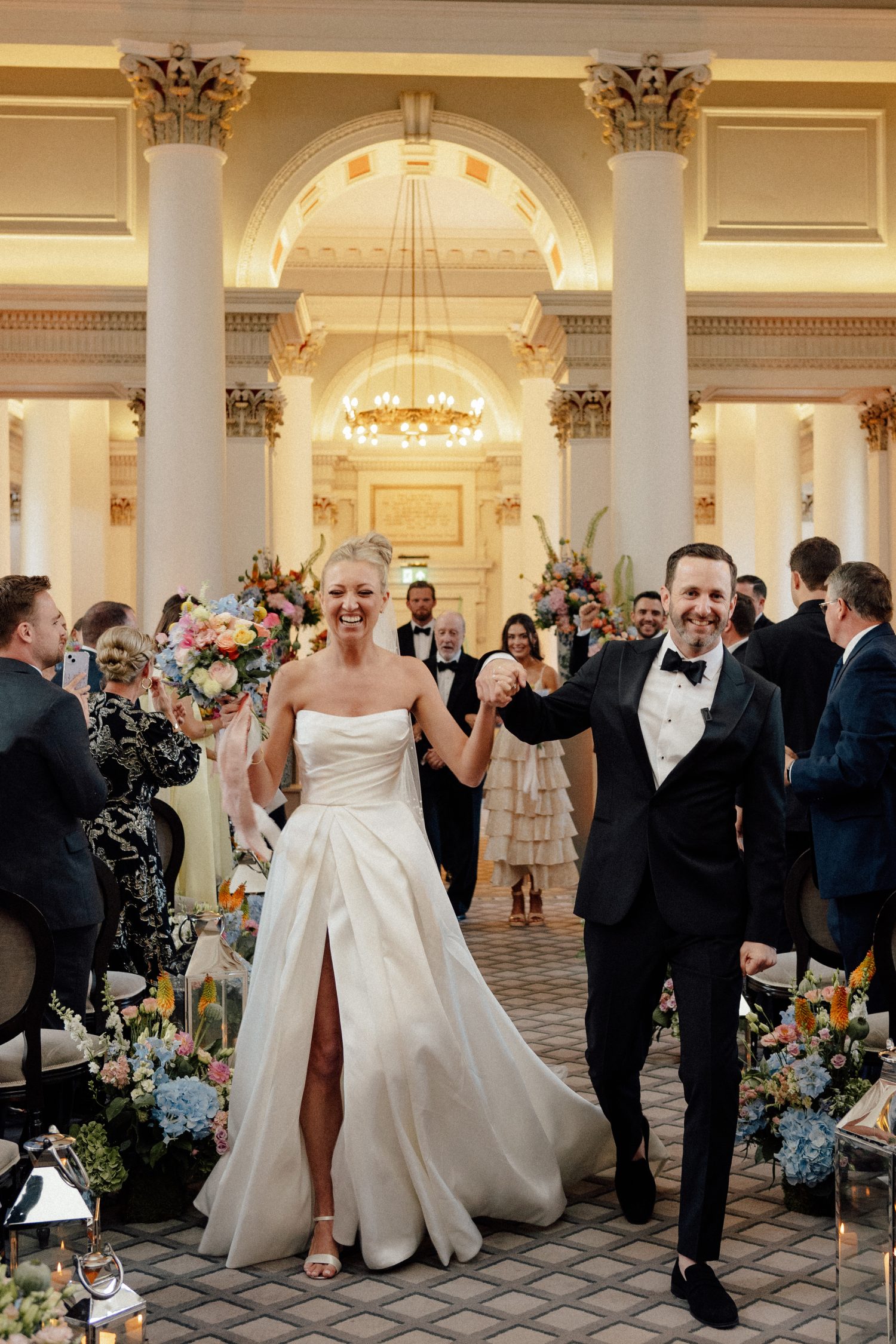 Karsyn & Conner walking down the aisle at the Signet Library.
