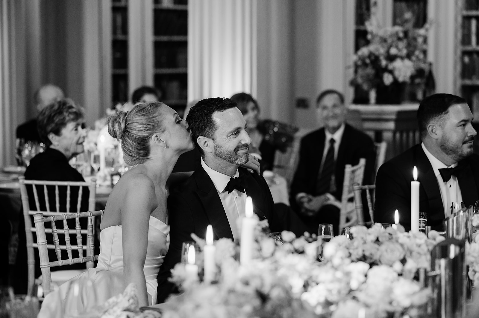 Bride kissing the groom during speeches at the Signet Library in Edinburgh.