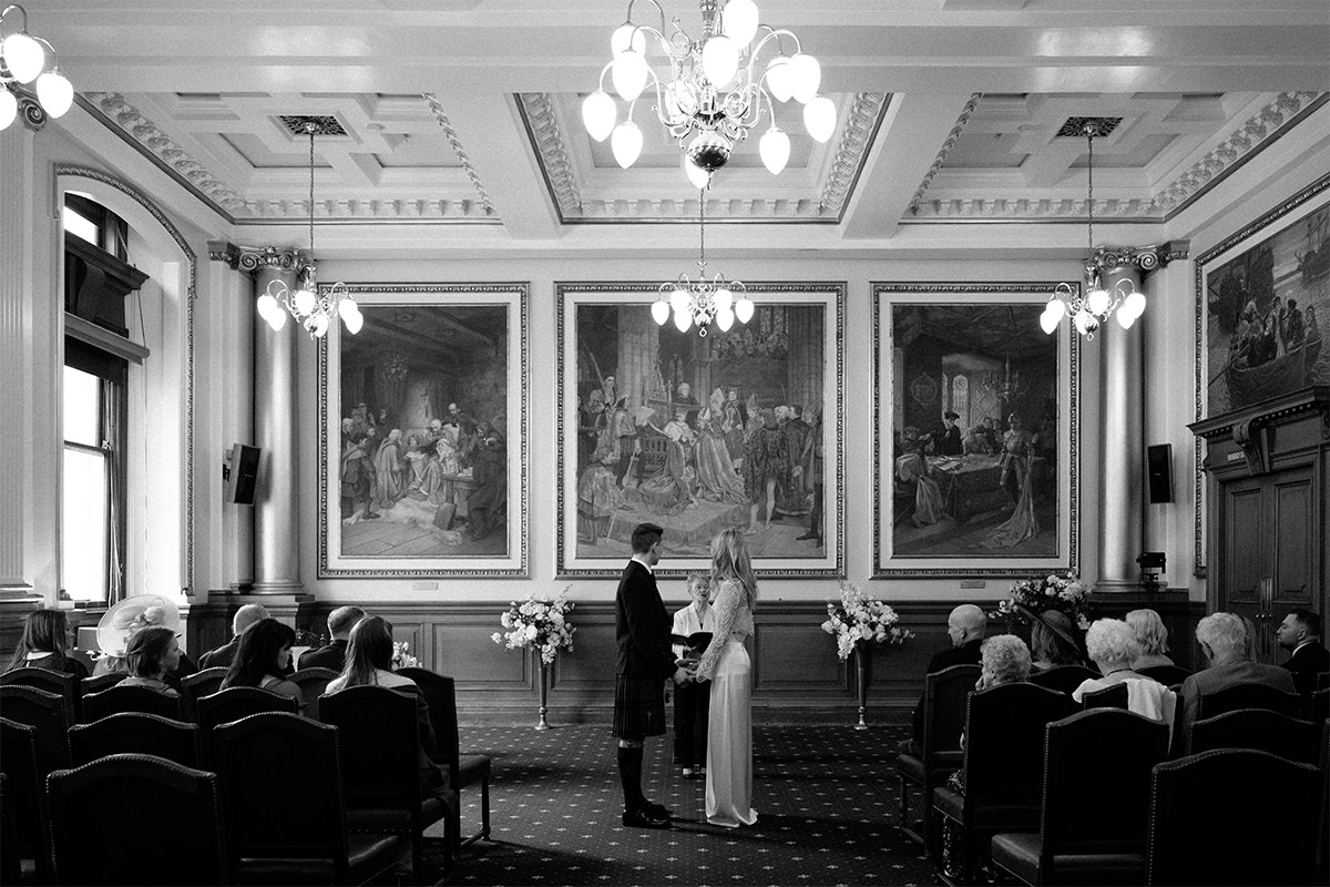 Wedding couple during their wedding ceremony at the city chambers in Edinburgh.