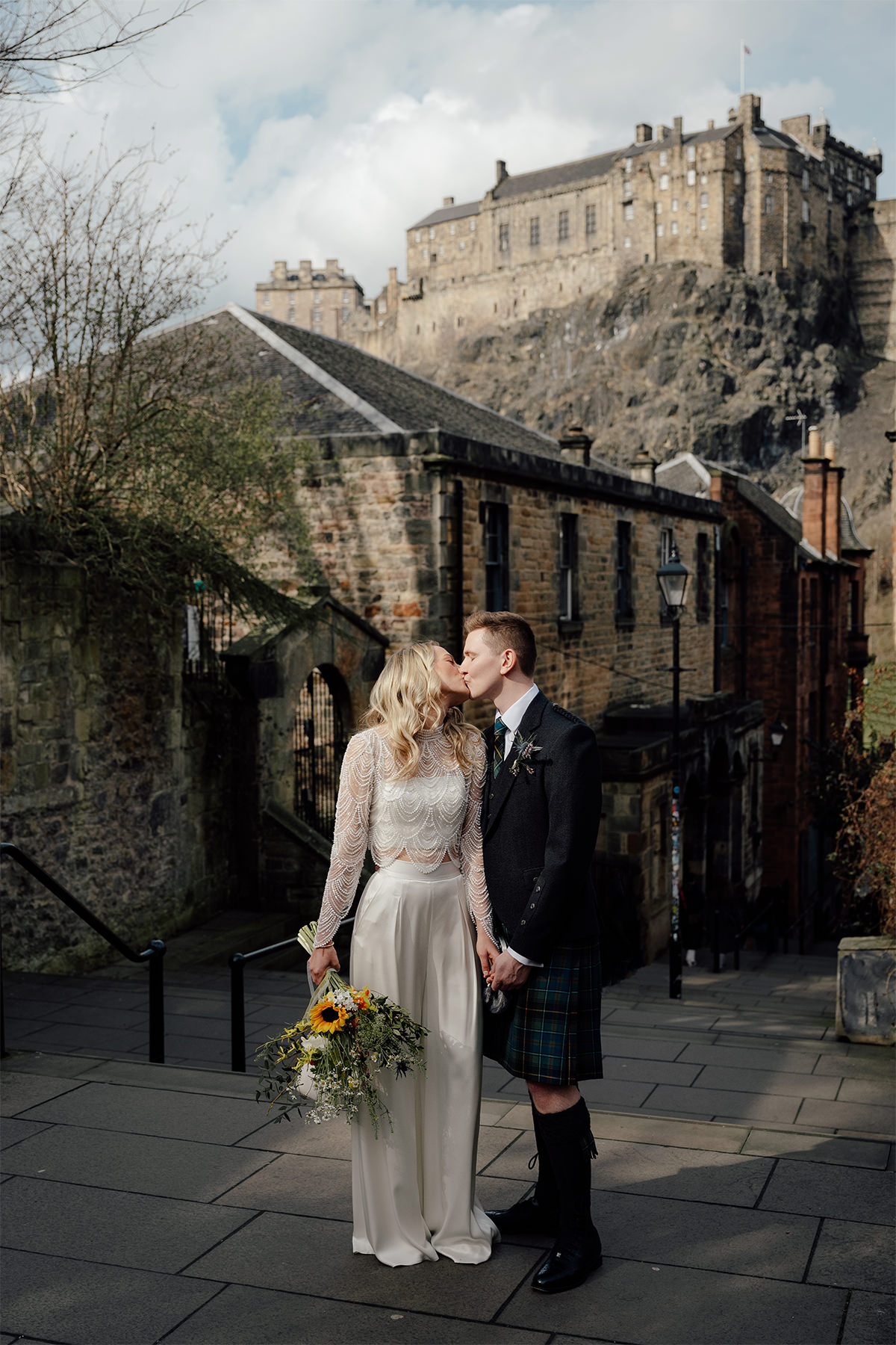 Wedding couple kissing at the Vennel in Edinburgh posing for their wedding photos.