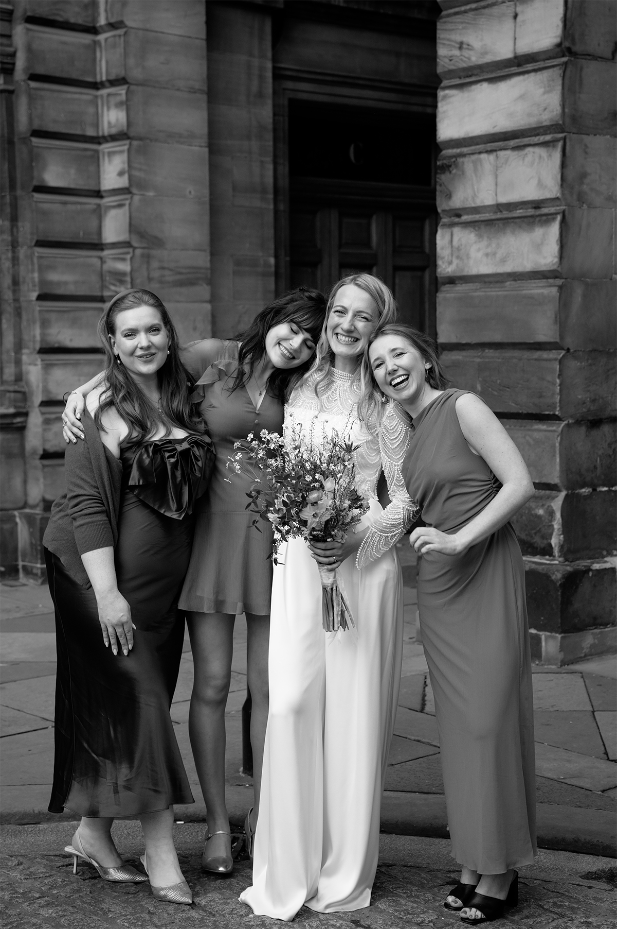 Bride posing with her friends outside the City Chambers.
