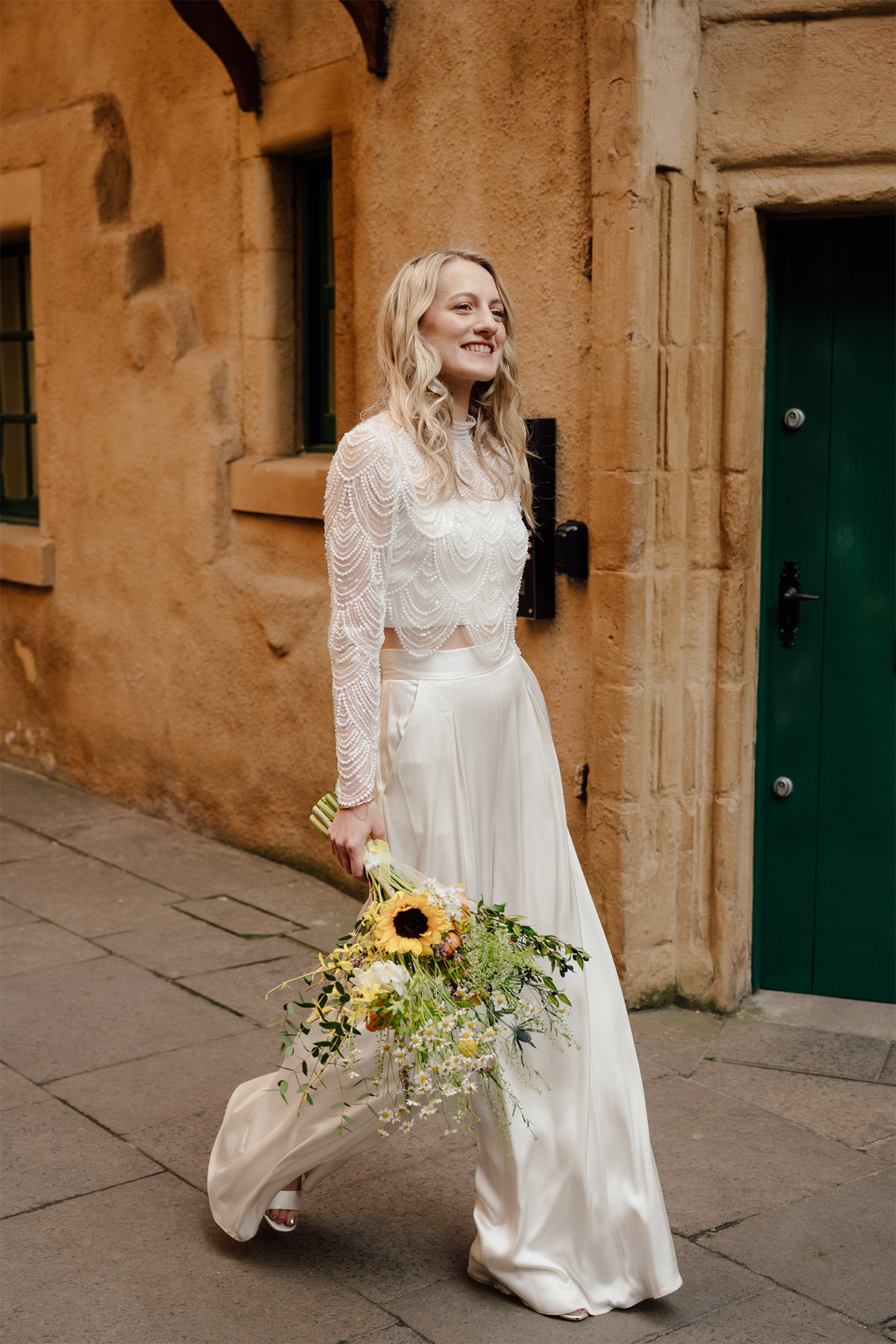 Hannah wearing bridal jumpsuit with stylish top.
