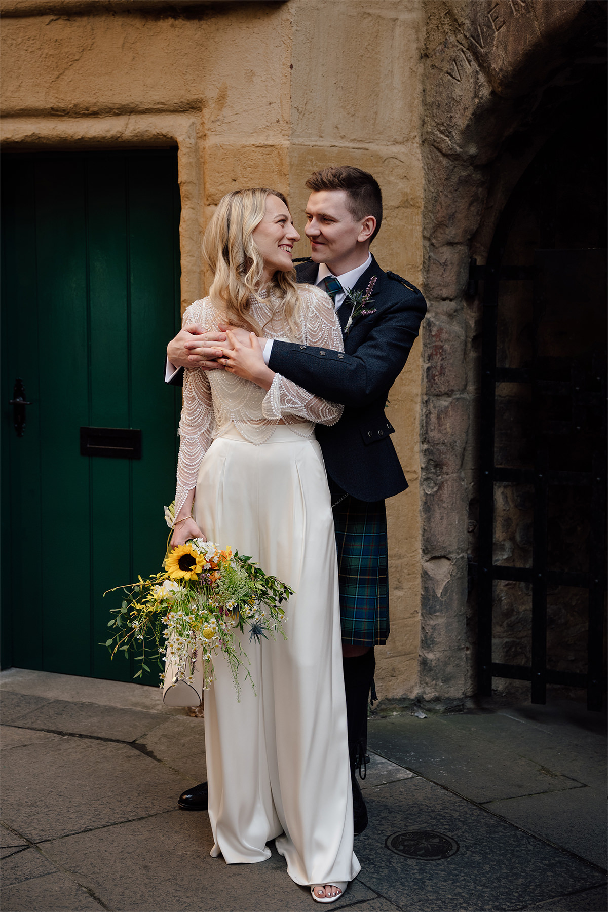 Hannah and Stuart posing for their wedding photos in Edinburgh.