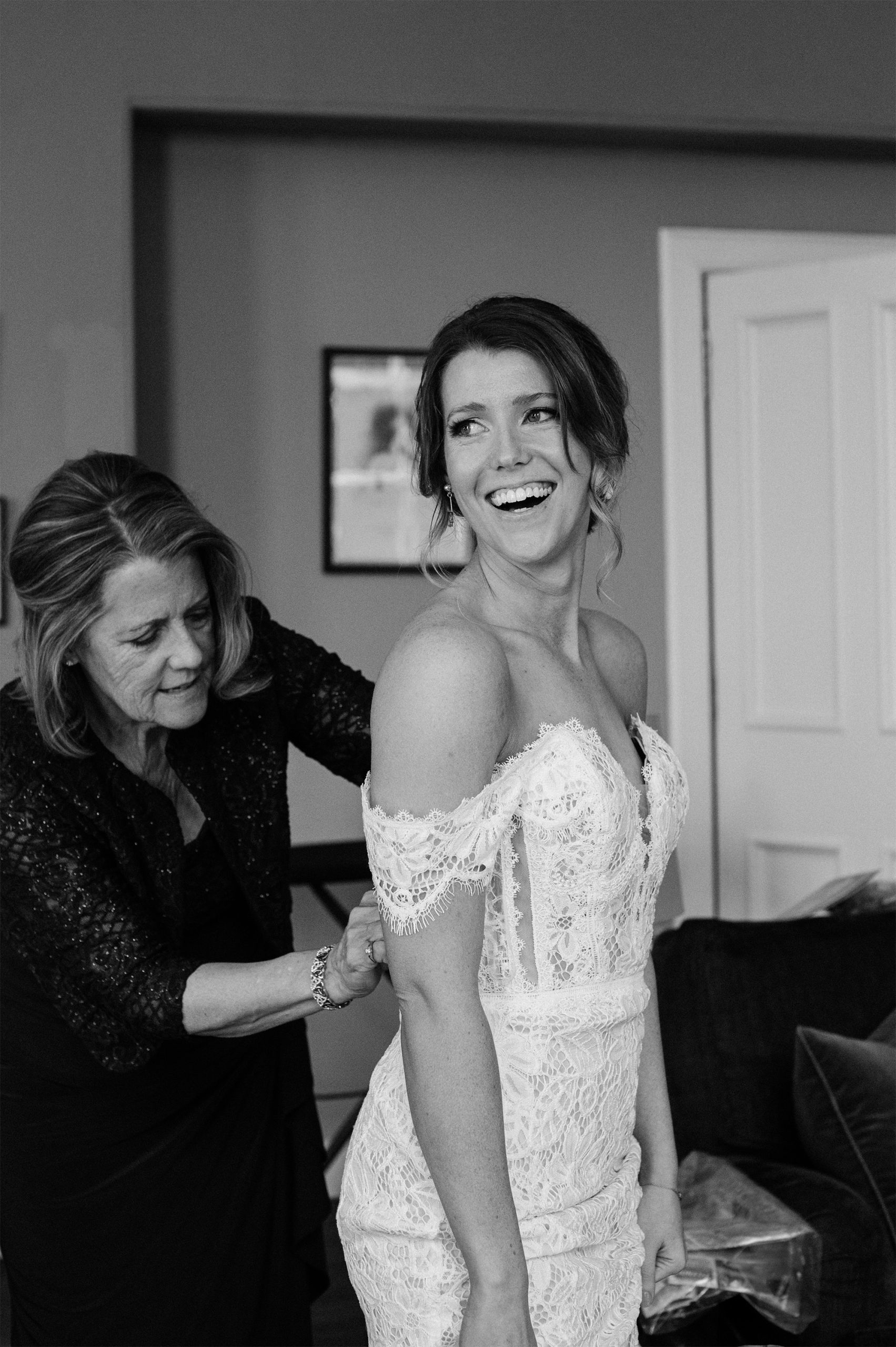 Shelby's mom helping putting on the dress.