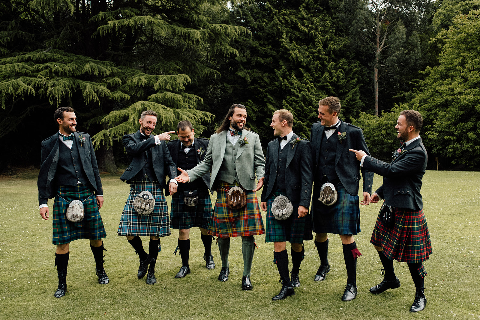 Groom walking with his groomsmen photographed by Edinburgh wedding photographer.