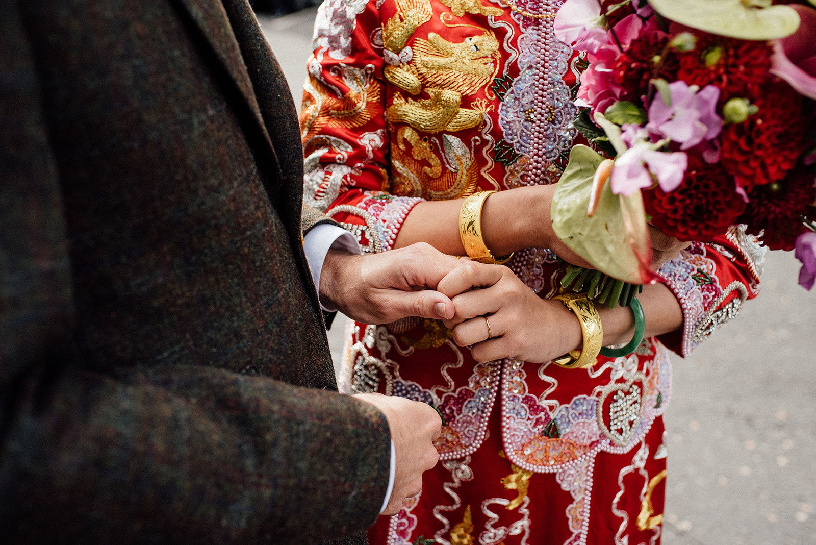 Chinese bride holding his husband's hand.