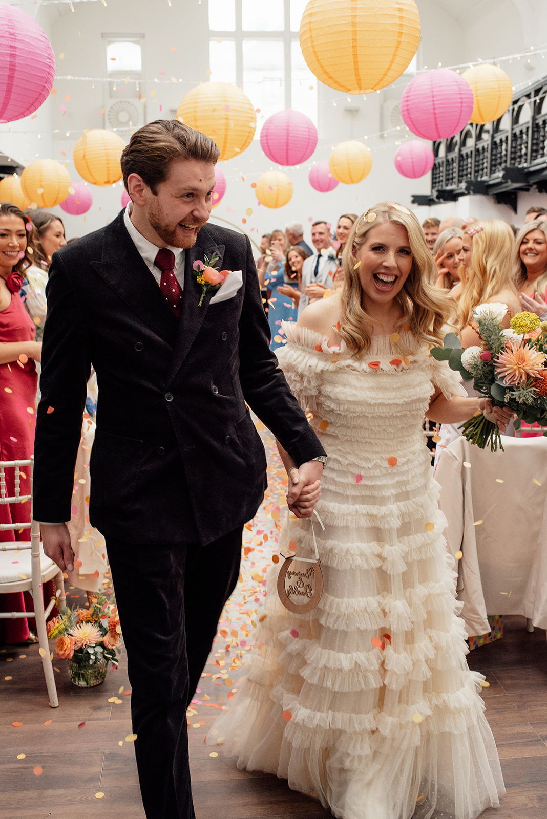 Wedding couple walking down the confetti aisle at the dr Bells Baths wedding venue.