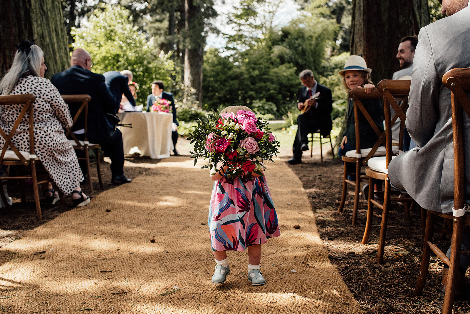 Flower girl walking with the bouquet at the royal botanic gardens in Edinburgh.
