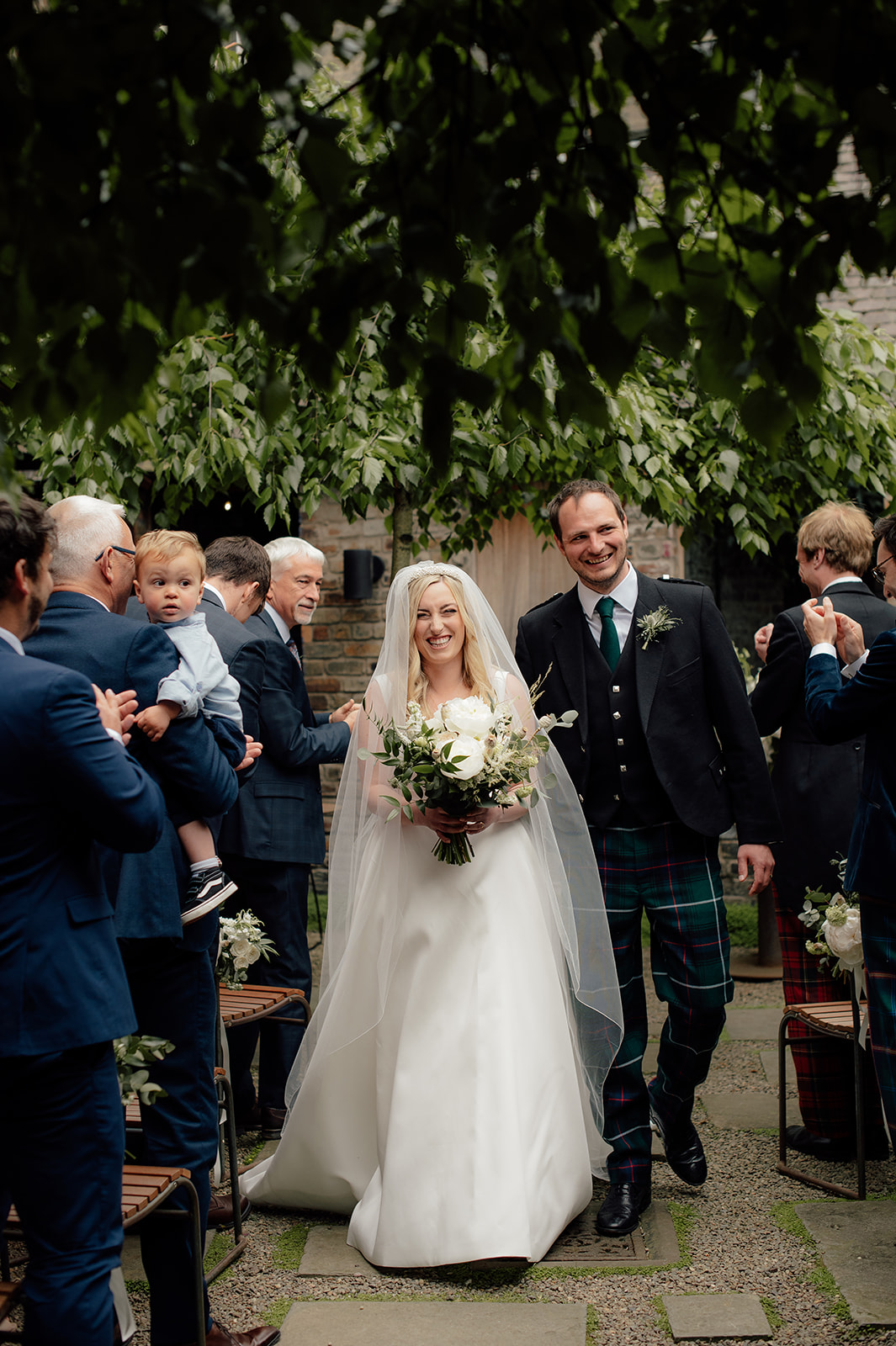 Sophie and Ian walking down the aisle at the Timberyard.