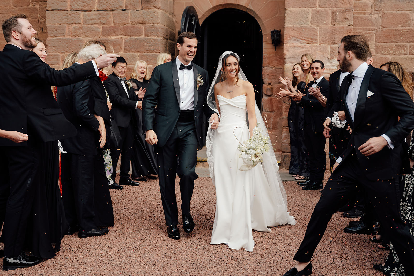 Mel and Kev leaving Dalhousie Castle for confetti throw.