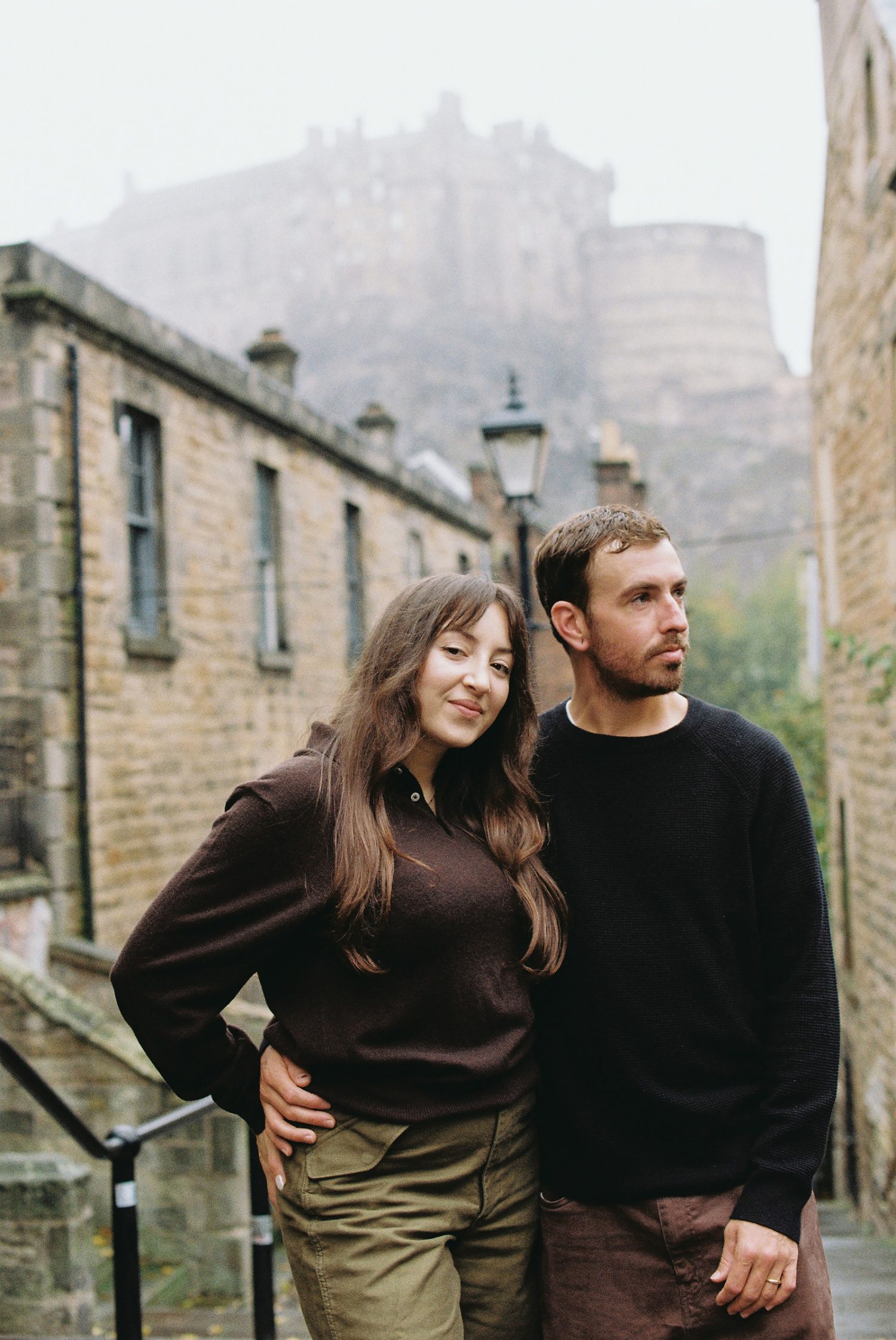 Romantic analogue portrait of newlyweds at the Vennel overlooking Edinburgh Castle.