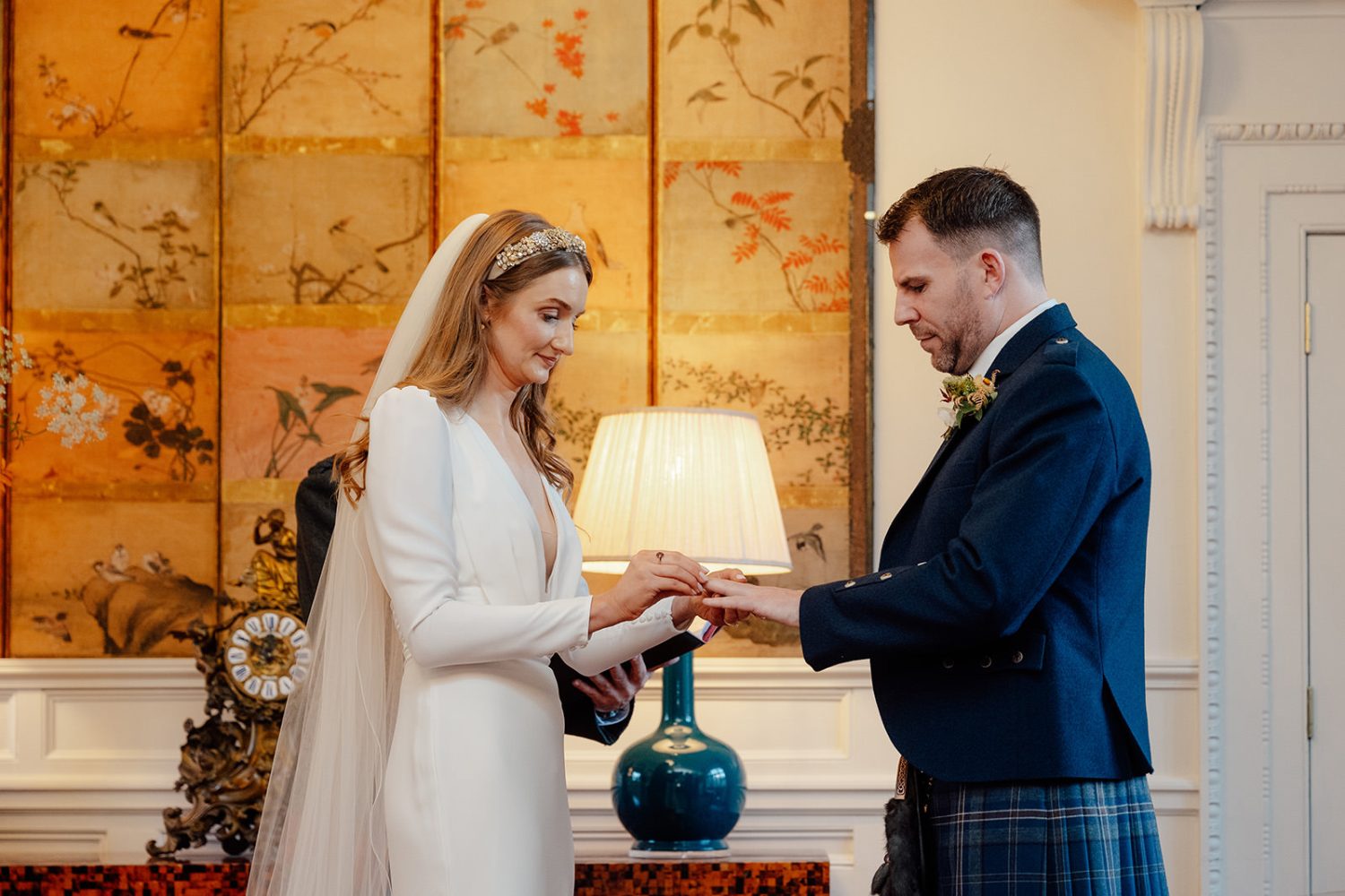 Katy and Ali exchanging wedding rings at the Penicuik House.