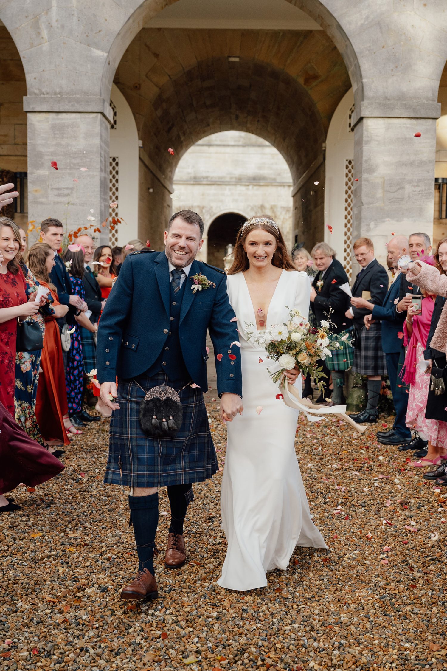 Katy and Ali walking down the confetti aisle after getting married at the Penicuik House.