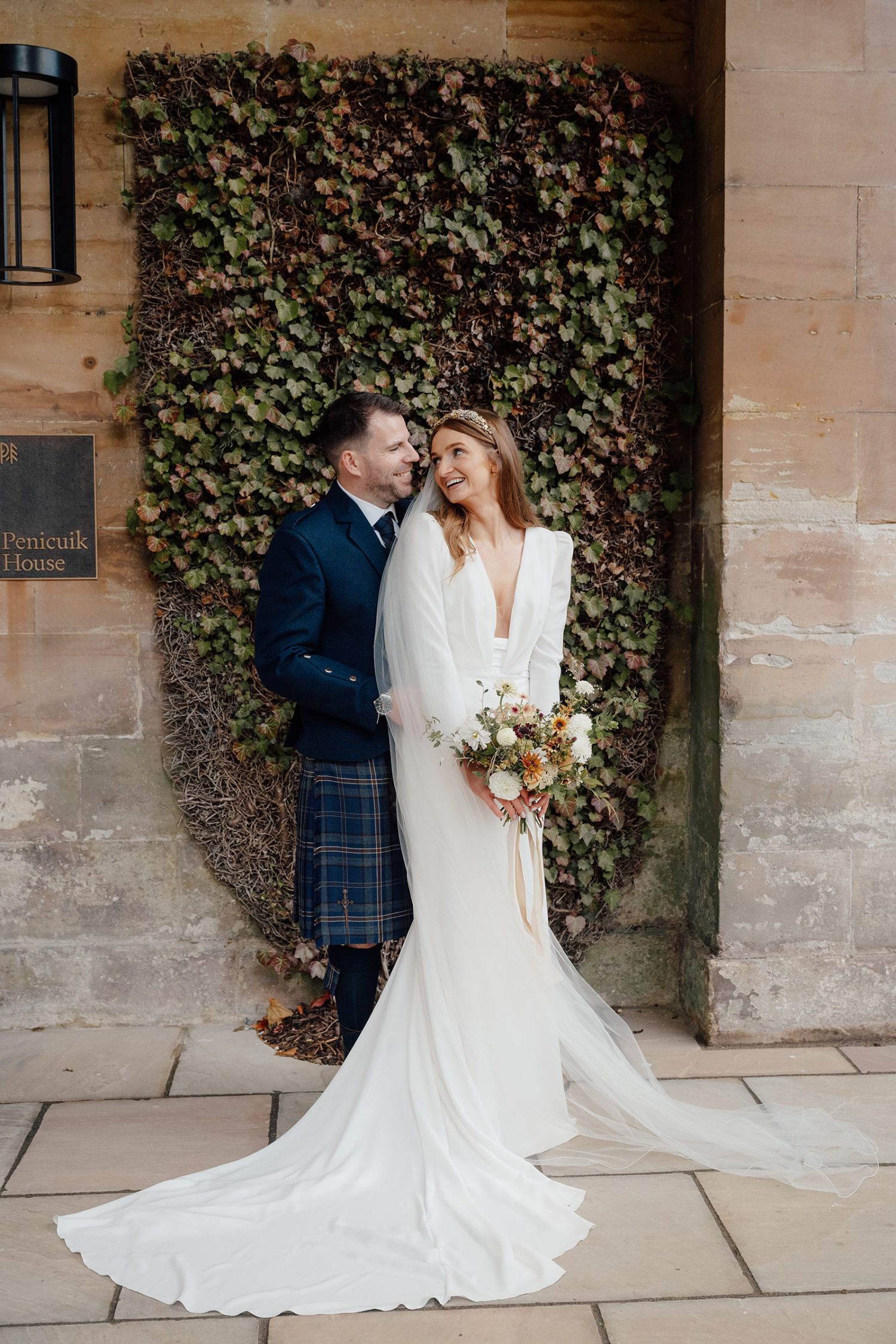 Bride and groom outside the Penicuik House posing for wedding photos.
