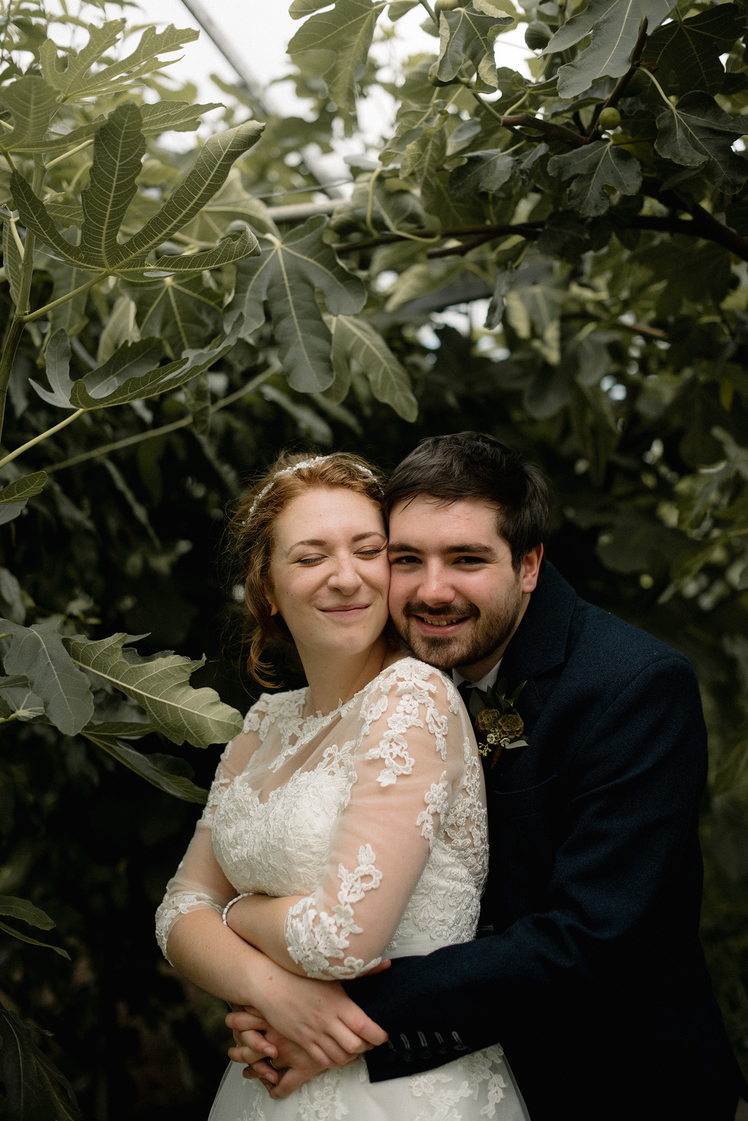 Couple posing for photos at their wedding at Secret Herb Garden.