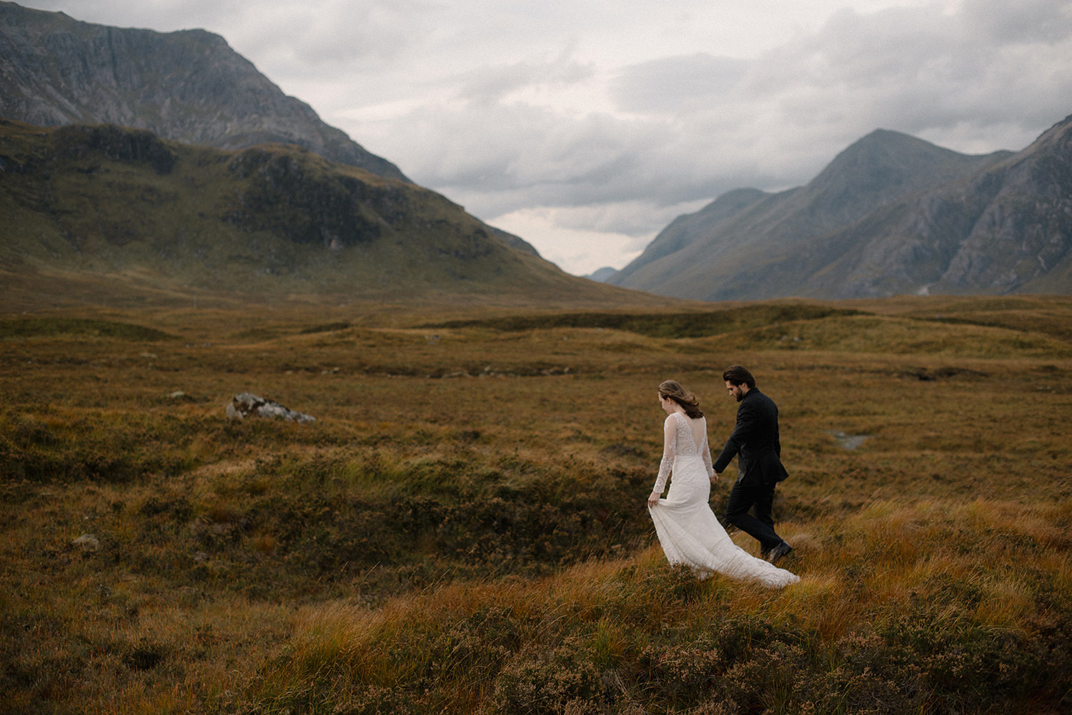 Scotland elopement photographer captures couple walking in Glencoe. 