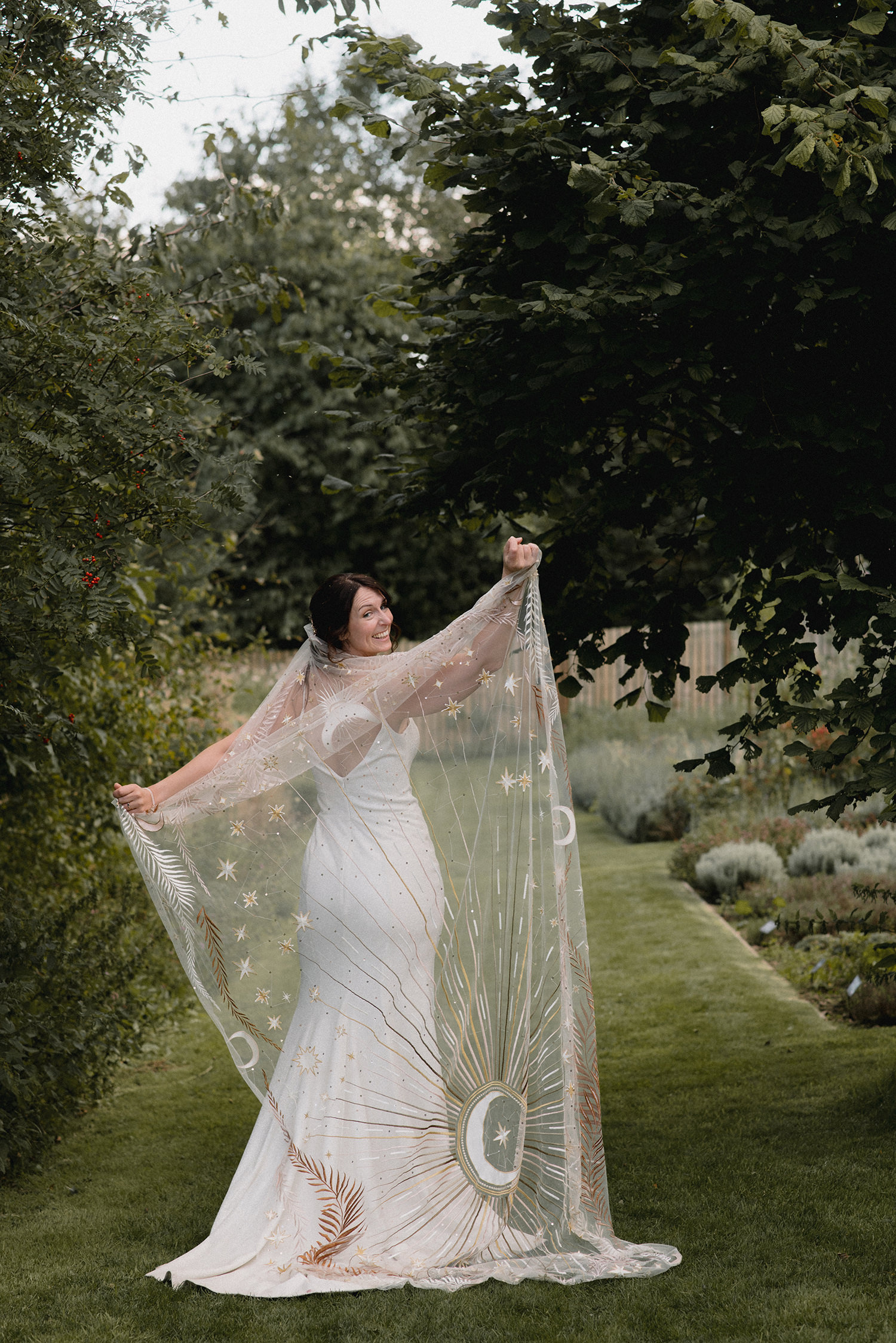 Bride posing with her veil at the Secret Herb Garden.